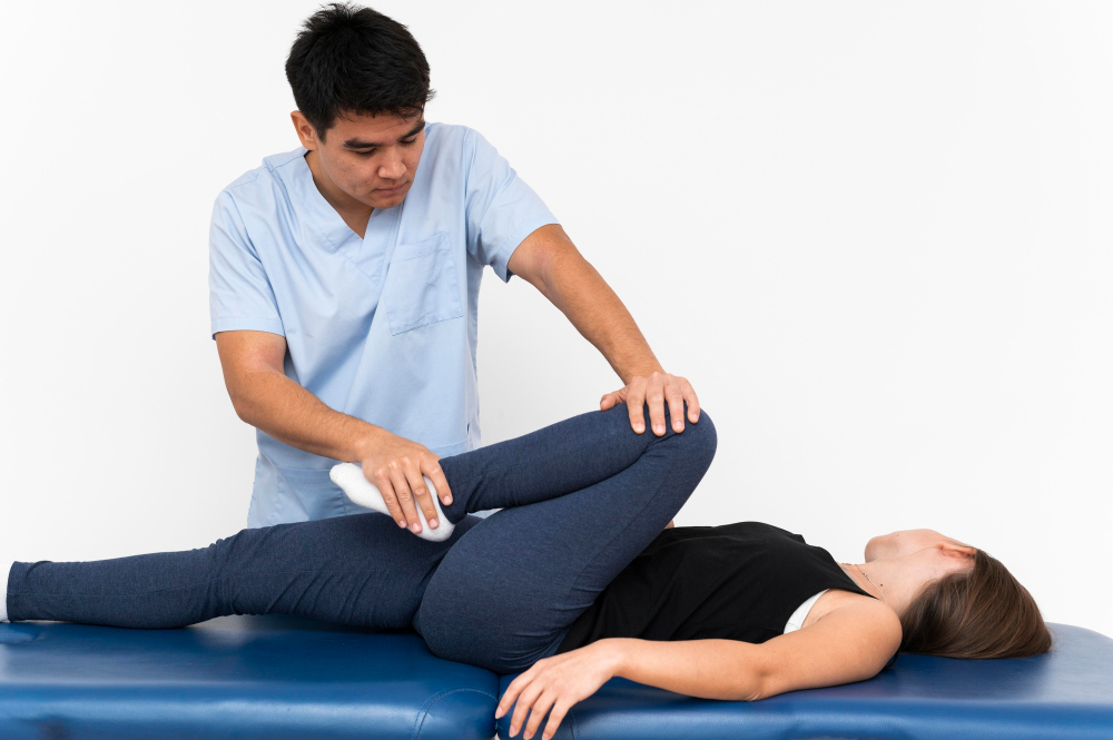 physiotherapist-doing-leg-exercises-with-female-patient(1)